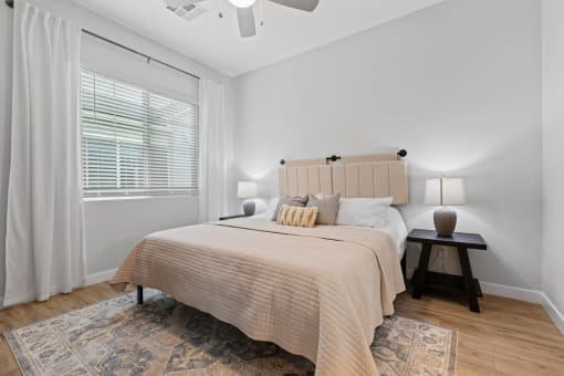 a bedroom with a large bed and a window at Village of Chandler Apartments, Arizona
