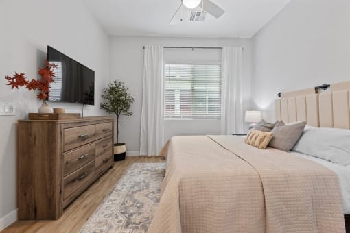 a bedroom with a bed and a tv at Village of Chandler Apartments, Chandler, AZ, 85249
