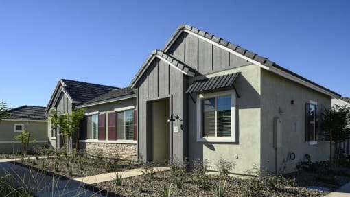 the front of a house with a driveway and a sidewalk at Village of Chandler Apartments, Chandler, 85249