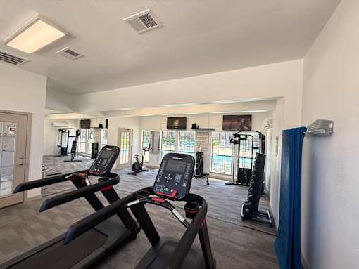 A gym with treadmills and exercise equipment.