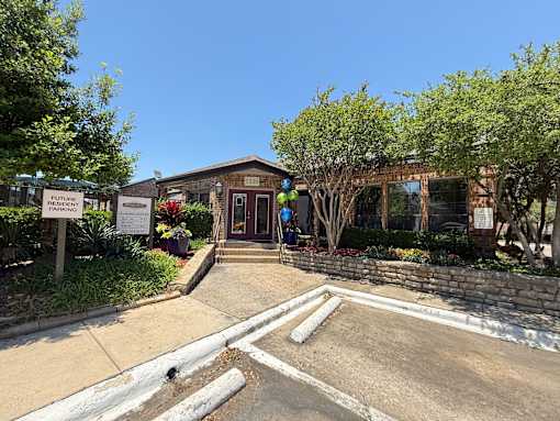 The image shows a building with a sign that reads "Future Resident" in front of it.