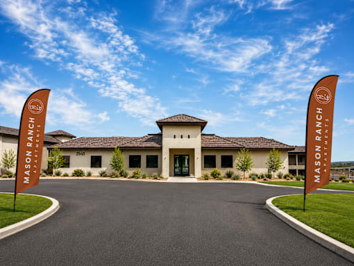 The entrance to Mason Ranch Resort with two flags on either side.