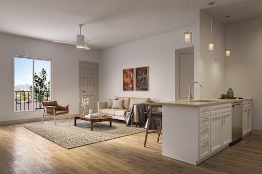 A modern living room with a kitchen area in the background.