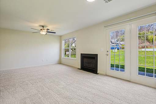 A room with a fireplace and a ceiling fan.