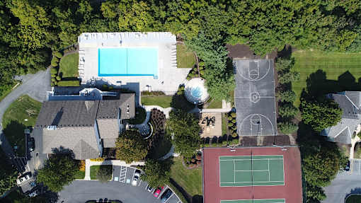 aerial of tennis court, clubhouse and pool