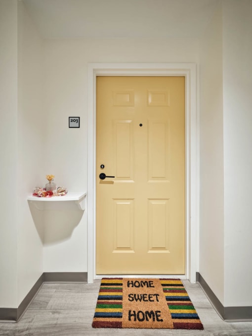 a yellow door in a white room
