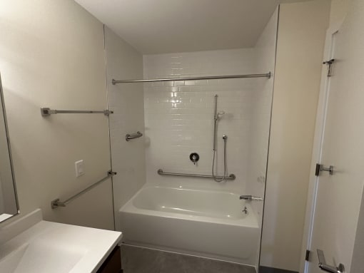 a small bathroom with a shower and a sink