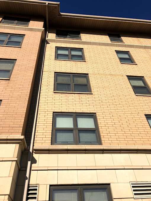 A tall building with many windows is shown in the image.