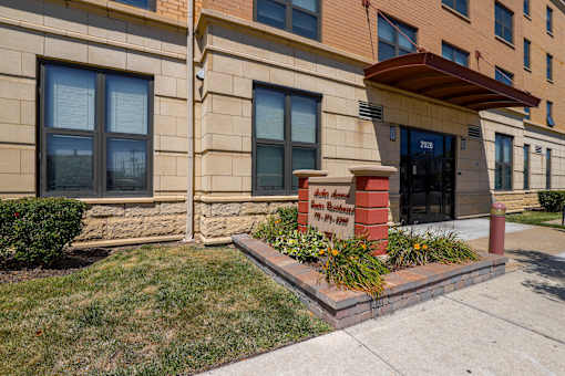 The front of a building with a sign that reads Archer Avenue Senior Housing