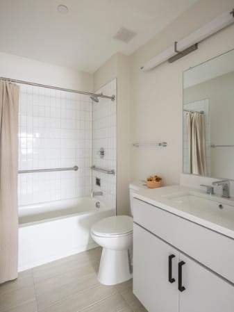 A white bathroom with a toilet, sink, and bathtub.