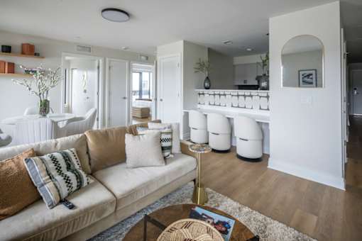 A living room with a beige couch and a coffee table.