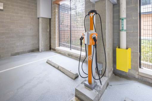 A charging station for electric vehicles is installed in a parking area.