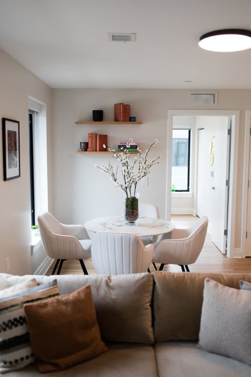 a living room with a table and chairs and a couch
