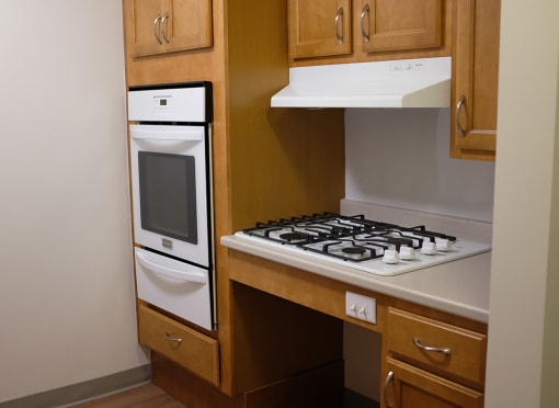 a small kitchen with a stove and a microwave