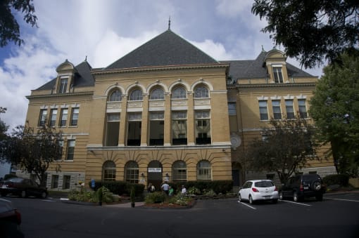 a large building with cars parked in front of it
