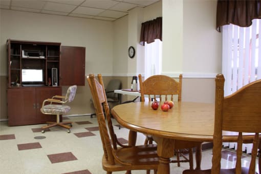 a dining room with a table and chairs