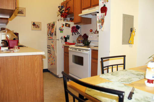 a kitchen with a table and a stove and a refrigerator