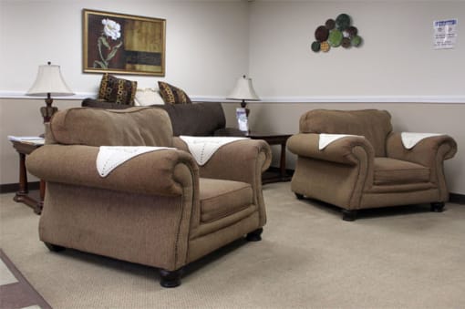 a living room with three chairs and a table
