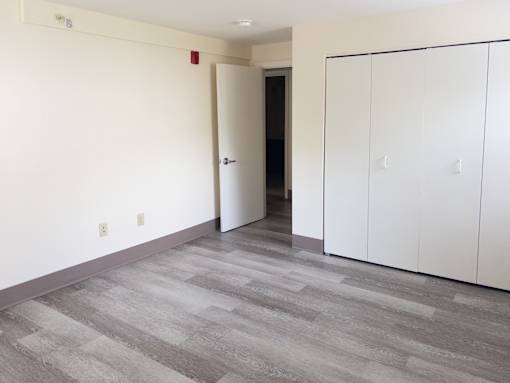 A room with a white door and a white cabinet.