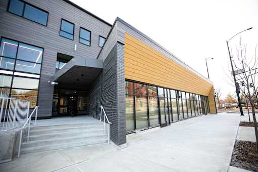 A modern building with a combination of grey and yellow panels.