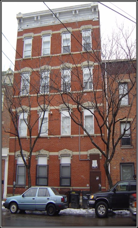 a red brick building with cars parked in front of it