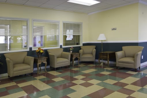 a waiting room with chairs and a checkered floor