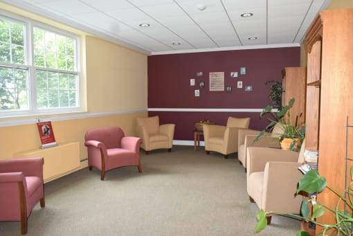 a waiting room at a hospital with chairs and tables
