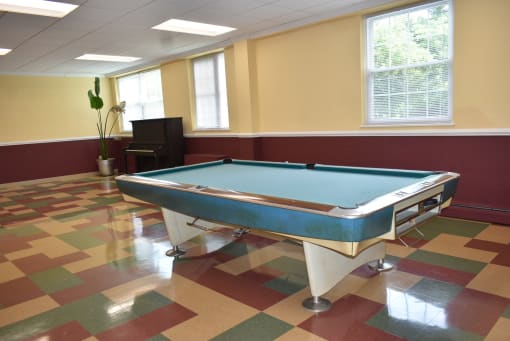 a game room with a pool table and a piano