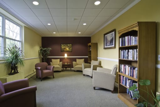 a waiting room at a library with chairs and a table