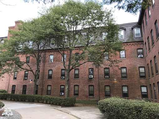 a red brick building with trees in front of it