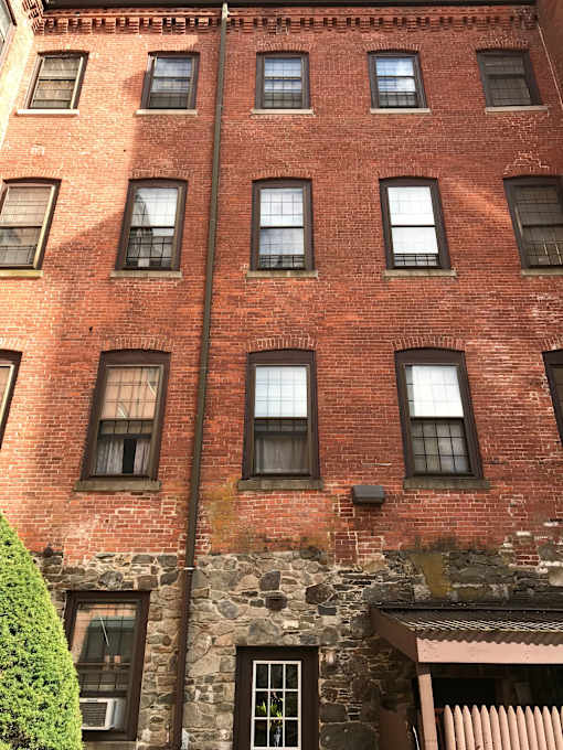 the side of a brick building with many windows