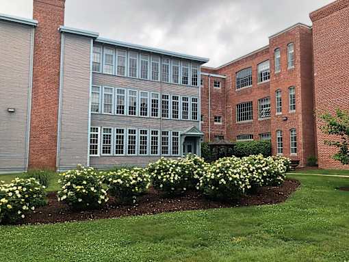 a view of the front of a building with flowers