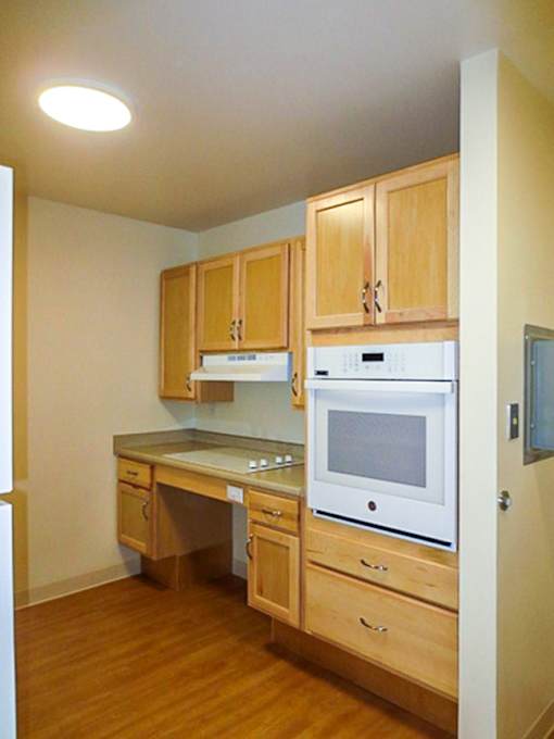 A kitchen with wooden cabinets and appliances.