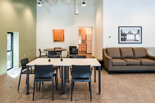 A conference room with a long table and chairs.
