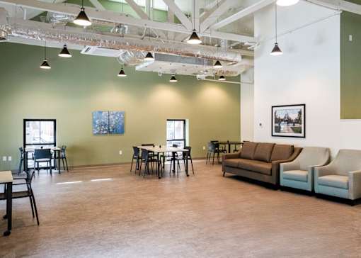 A room with couches and a table and chairs