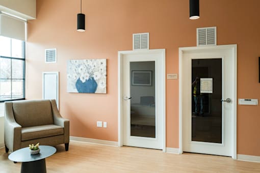 Lobby with two doors and a chair