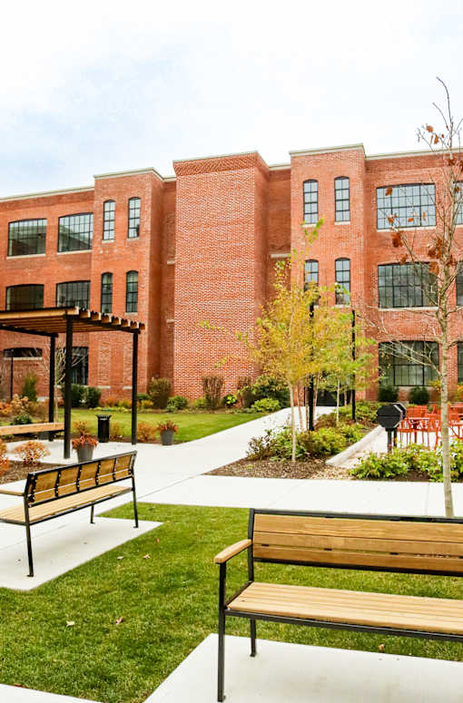A red brick building with a walkway in front of it.