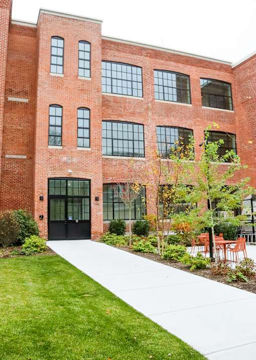 A red brick building with a black door and windows.