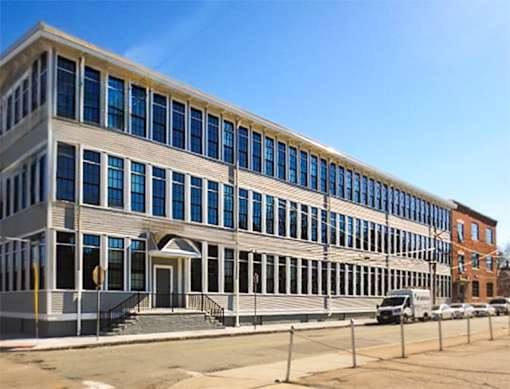 A large building with many windows and a white door.