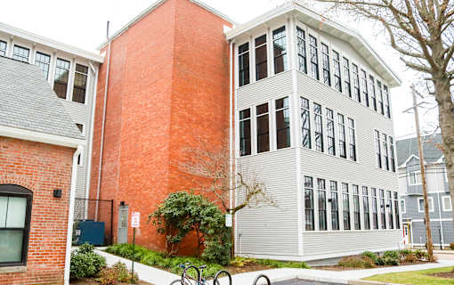 A red brick building with a white building next to it.