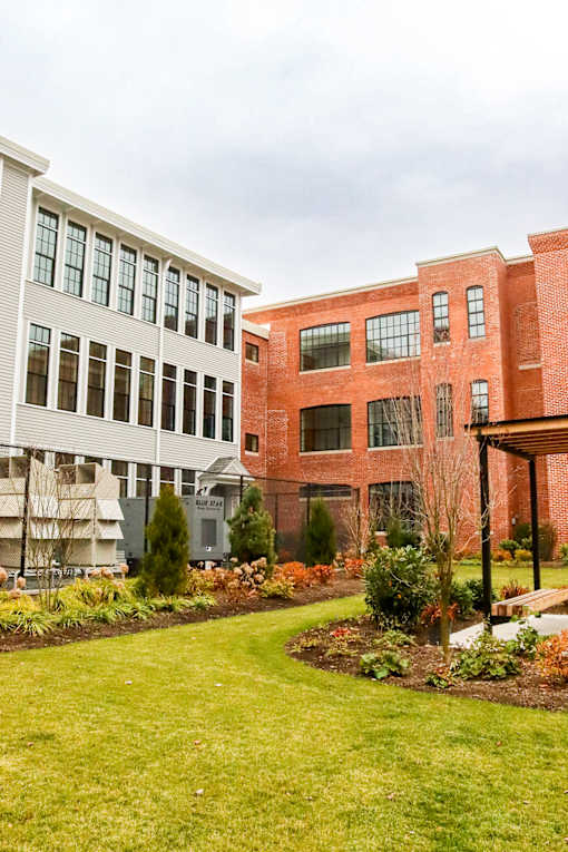 A red brick building with a white building next to it