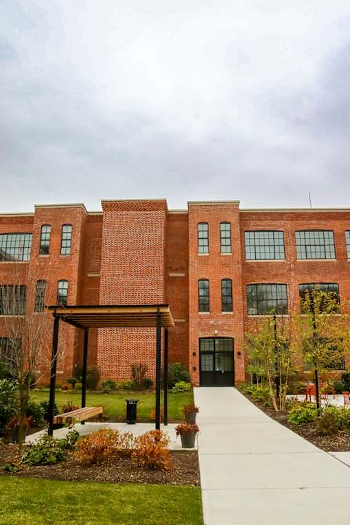 A red brick building with a black door and windows.