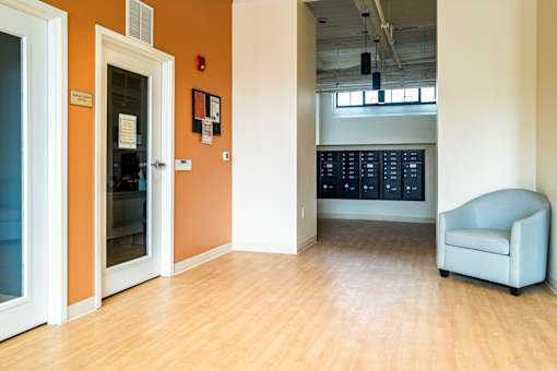 A room with a white chair and a white door.