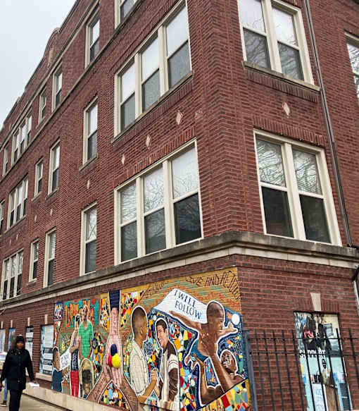 A mural on a brick building says "Will Follow".