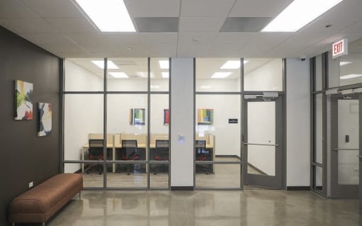 a conference room with glass doors and a table and chairs