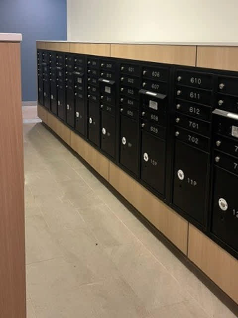 A row of black lockers with numbers on them.