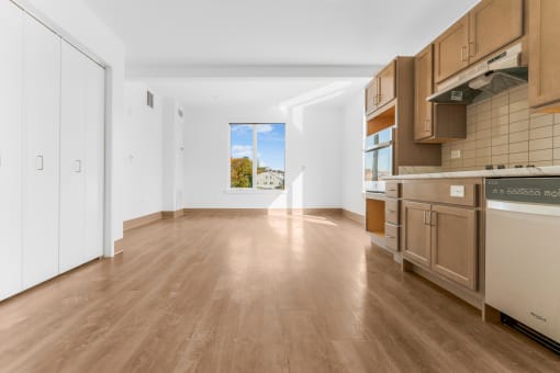 a kitchen with wooden floors and a window