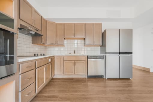 a kitchen with wooden cabinets and stainless steel appliances