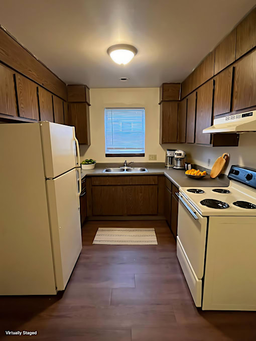 A kitchen with a white refrigerator and a white stove.