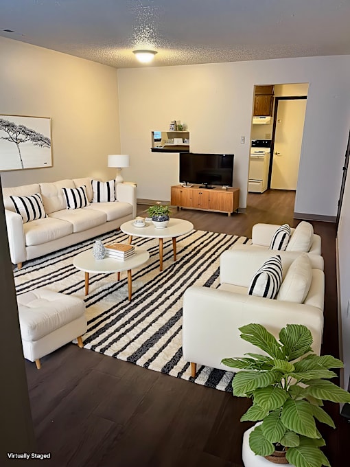 A living room with a white couch and a coffee table.